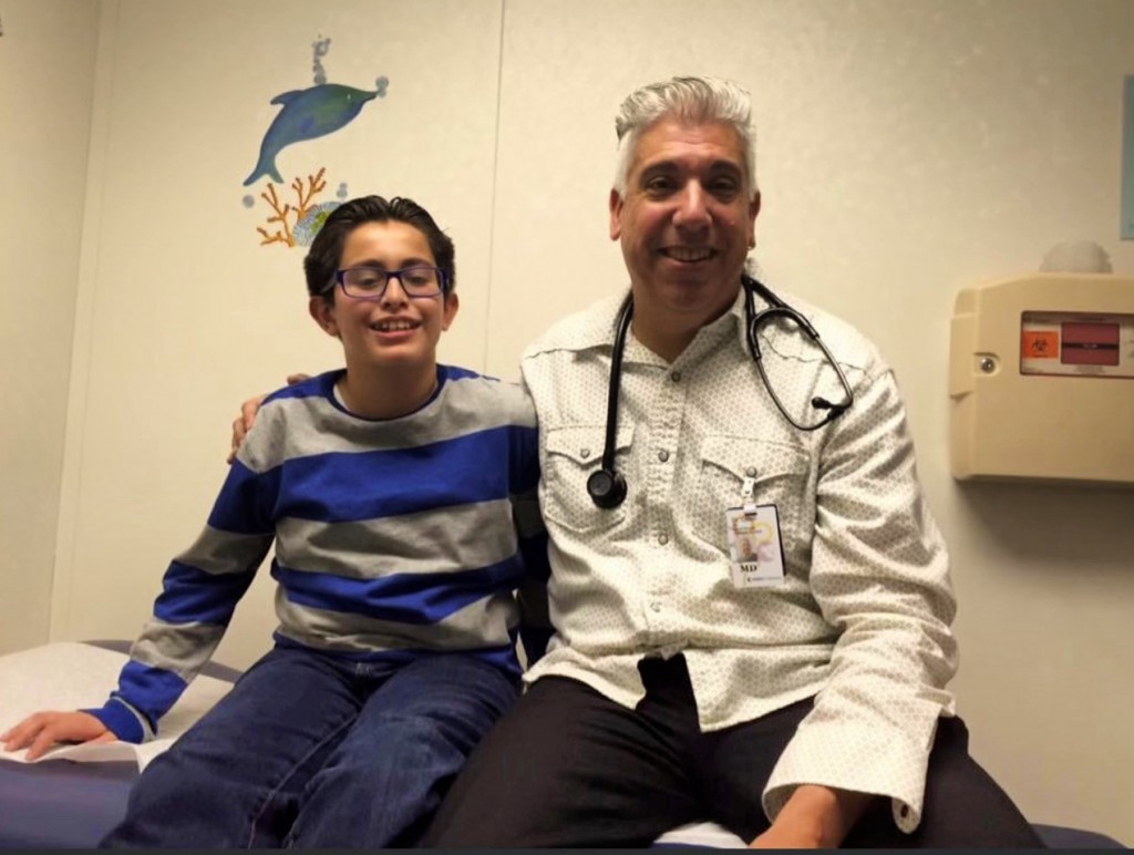 Jair and Dr. Colon at a clinic visit (photo taken before the pandemic)